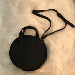 Black circular crossbody bag.